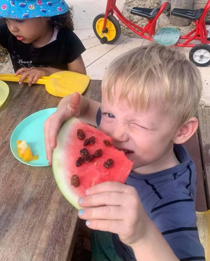 Child enjoying fresh watermelon