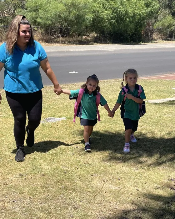 Educator walking children to school