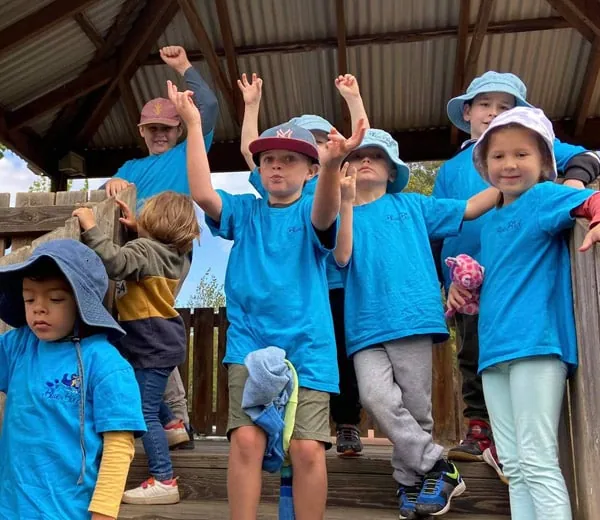 Children in Bluebird shirts cheering